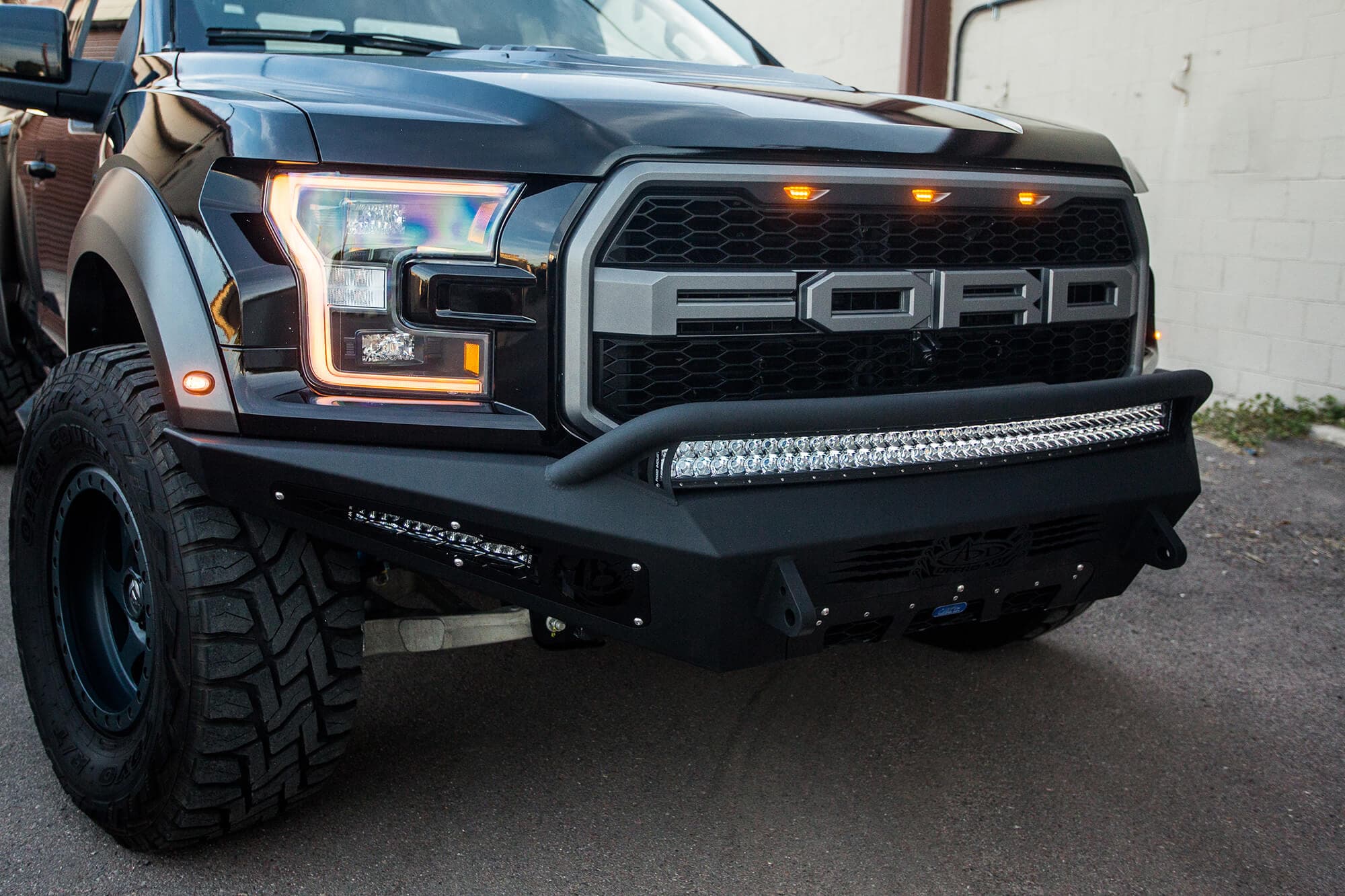 2017 Ford Raptor Honeybadger Front Bumper With Ecoboost Venting And 40 Rds LED Bar Mounts With hb Logo Cutout With 10 LED Bar Mounts And Dually Mounts in Sides Panels in Hammer Black With Satin Black Panels product image