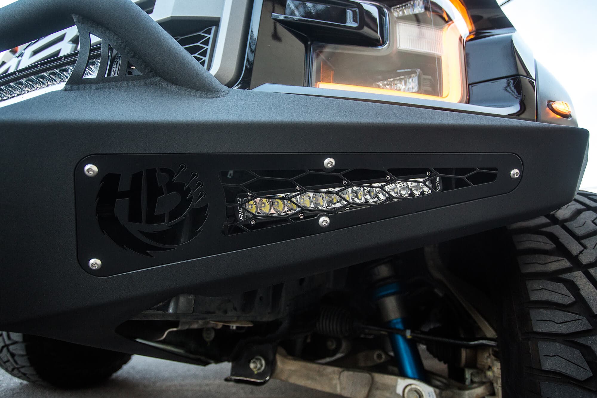 2017 Ford Raptor Honeybadger Front Bumper With Ecoboost Venting And 40 Rds LED Bar Mounts With hb Logo Cutout With 10 LED Bar Mounts And Dually Mounts in Sides Panels in Hammer Black With Satin Black Panels product image
