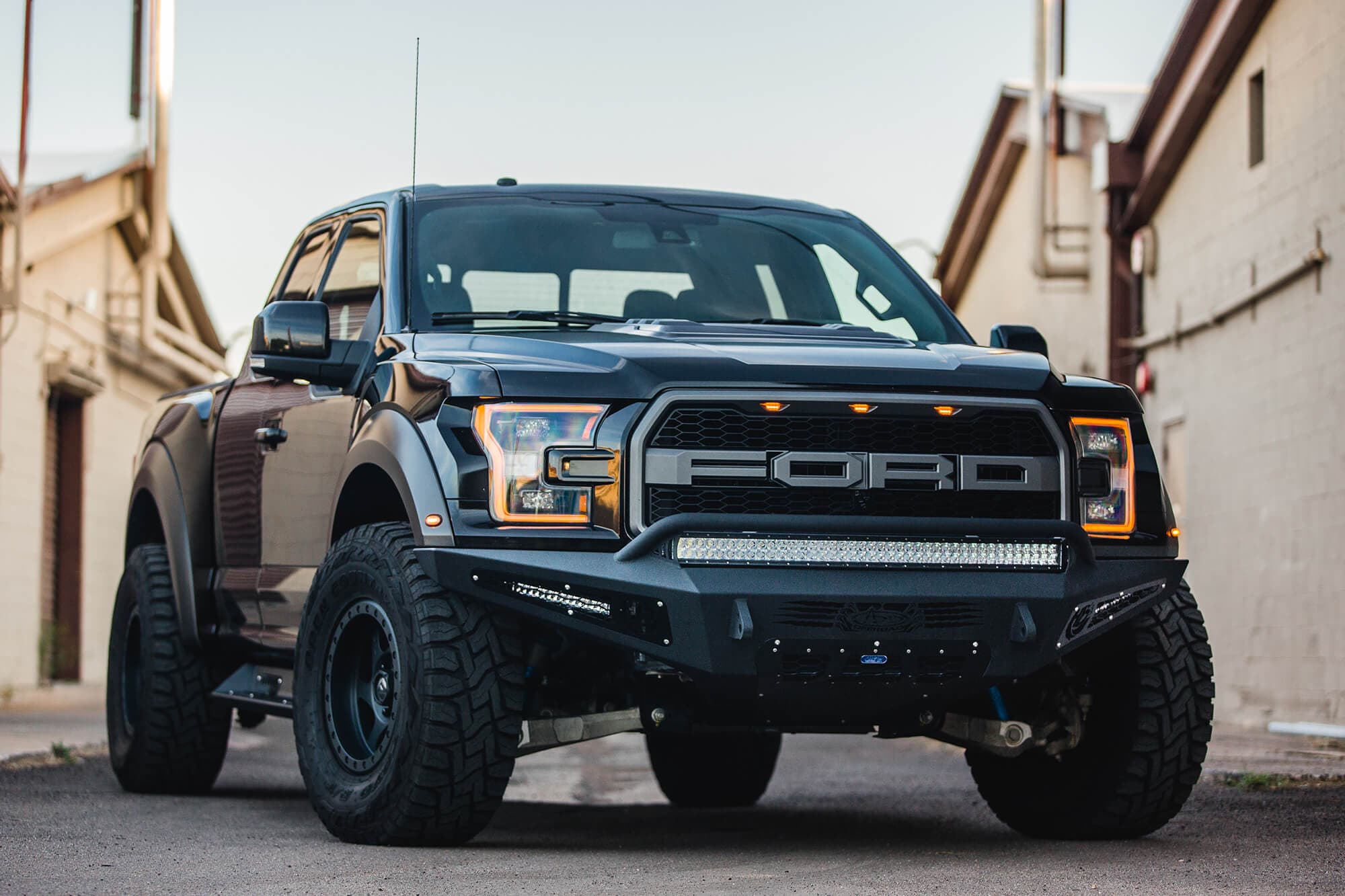 2017 Ford Raptor Honeybadger Front Bumper With Ecoboost Venting And 40 Rds LED Bar Mounts With hb Logo Cutout With 10 LED Bar Mounts And Dually Mounts in Sides Panels in Hammer Black With Satin Black Panels product image