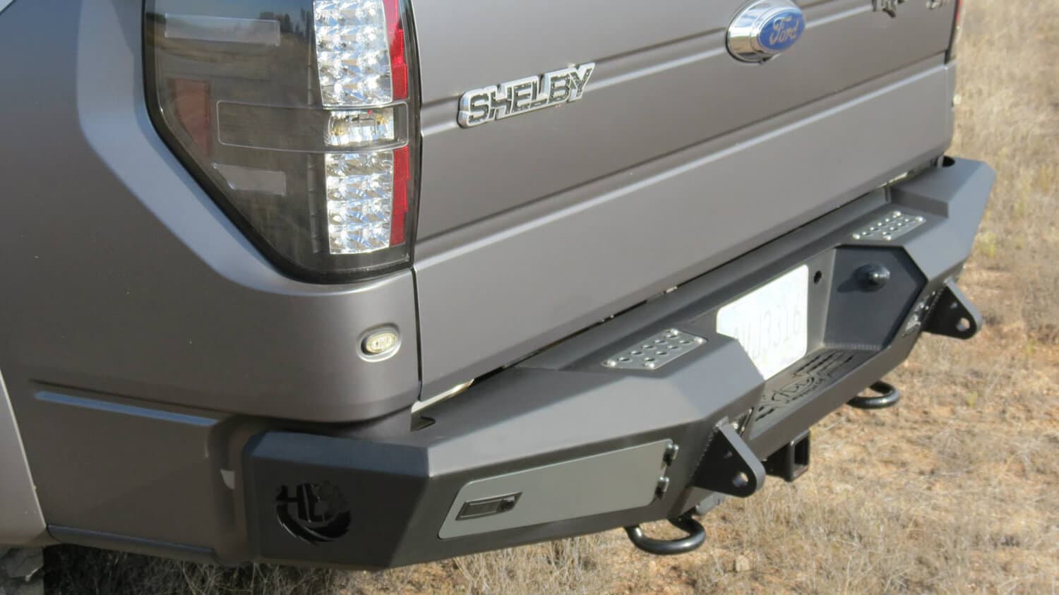 2010 - 2014 Ford Raptor 2009 - 2014 Ford F-150 2011 - 2014 Ford Ecoboost F-150 HoneyBadger Rear Bumper with Integrated Storage Box and Backup Sensor cutouts with Dually mounts in Hammer Black with Satin Black panels. product image