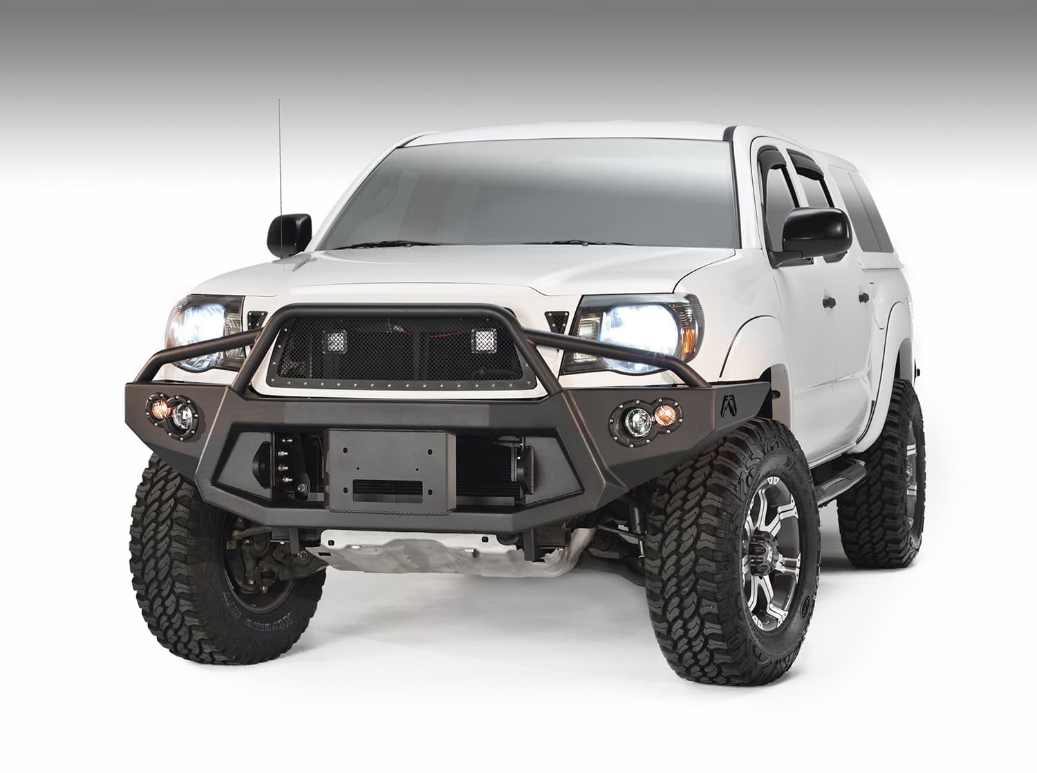 Premium Heavy Duty Winch Front Bumper; 2 Stage Black Powder Coated; w/Pre-Runner Grill Guard; Incl. 1in. D-Ring Mts./Light Cut-Outs w/Hella 90mm Fog Lamps/60mm Turn Signals; product image